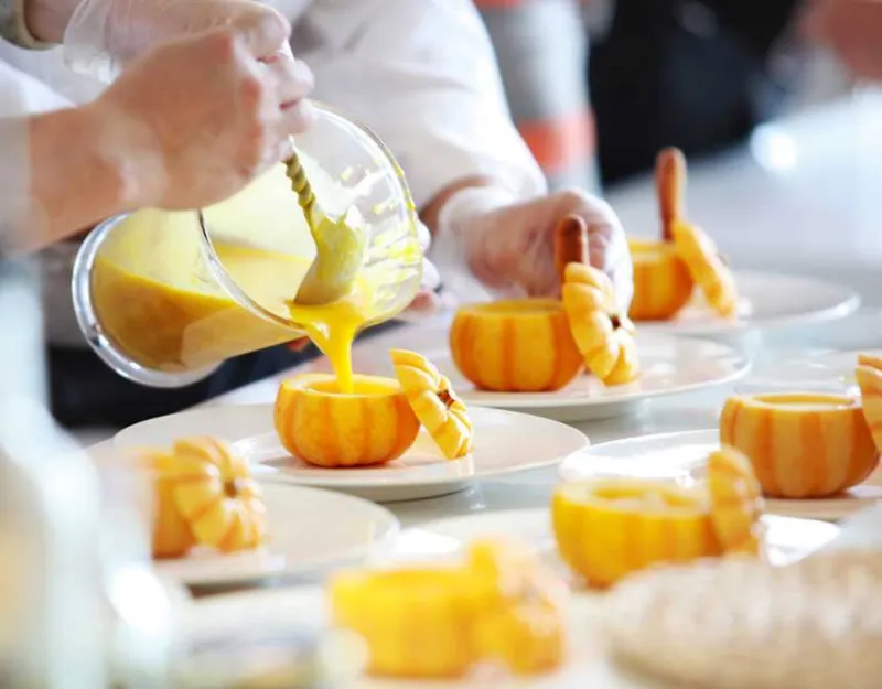 Fruit shake pouring in a small pumpkin