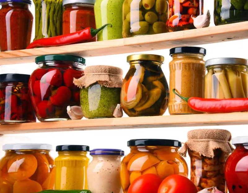 Fruits and vegetables in a jar on a shelf