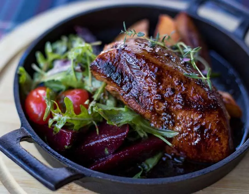 Grilled steak on black cooking pot