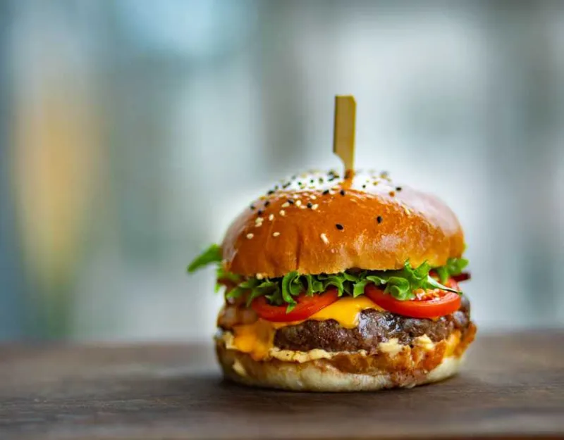 Photo of a juicy hamburger on a wooden surface