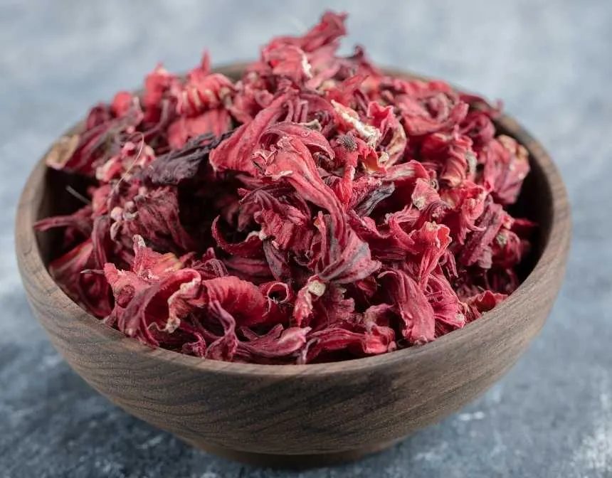 dried hibiscus petals in a wooden bowl