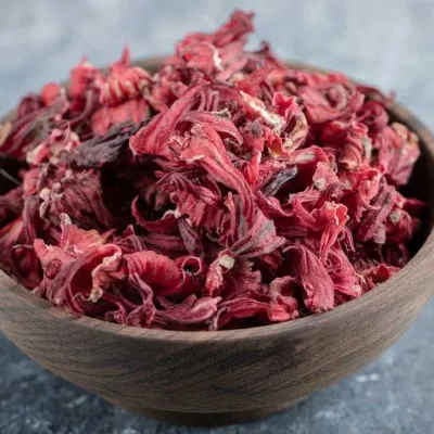 dried hibiscus petals in a wooden bowl