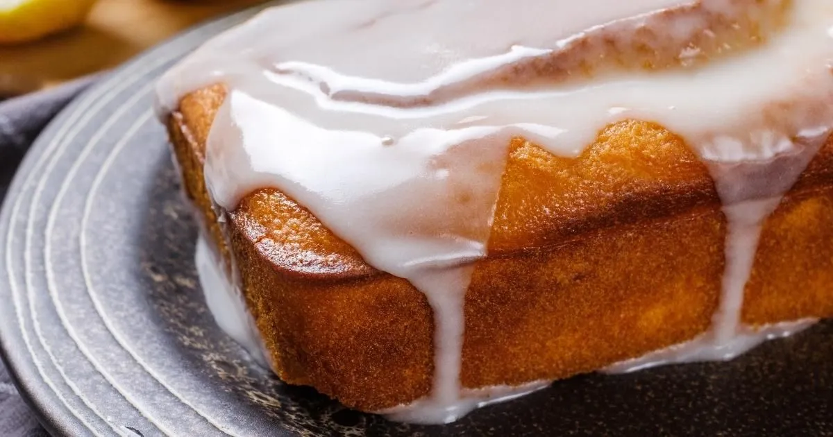Glazed lemon pound cake whole on a plate