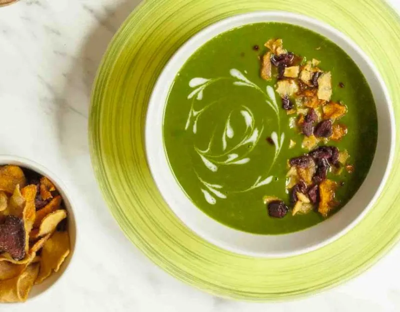 Cream of spinach soup near chips