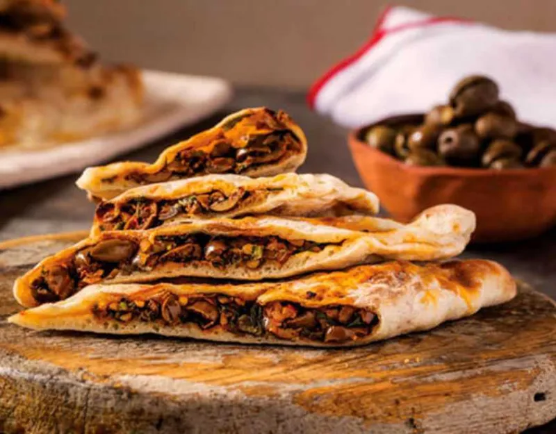Flat bread with green olives and ground beef