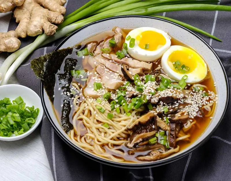Ramen broth with chopsticks